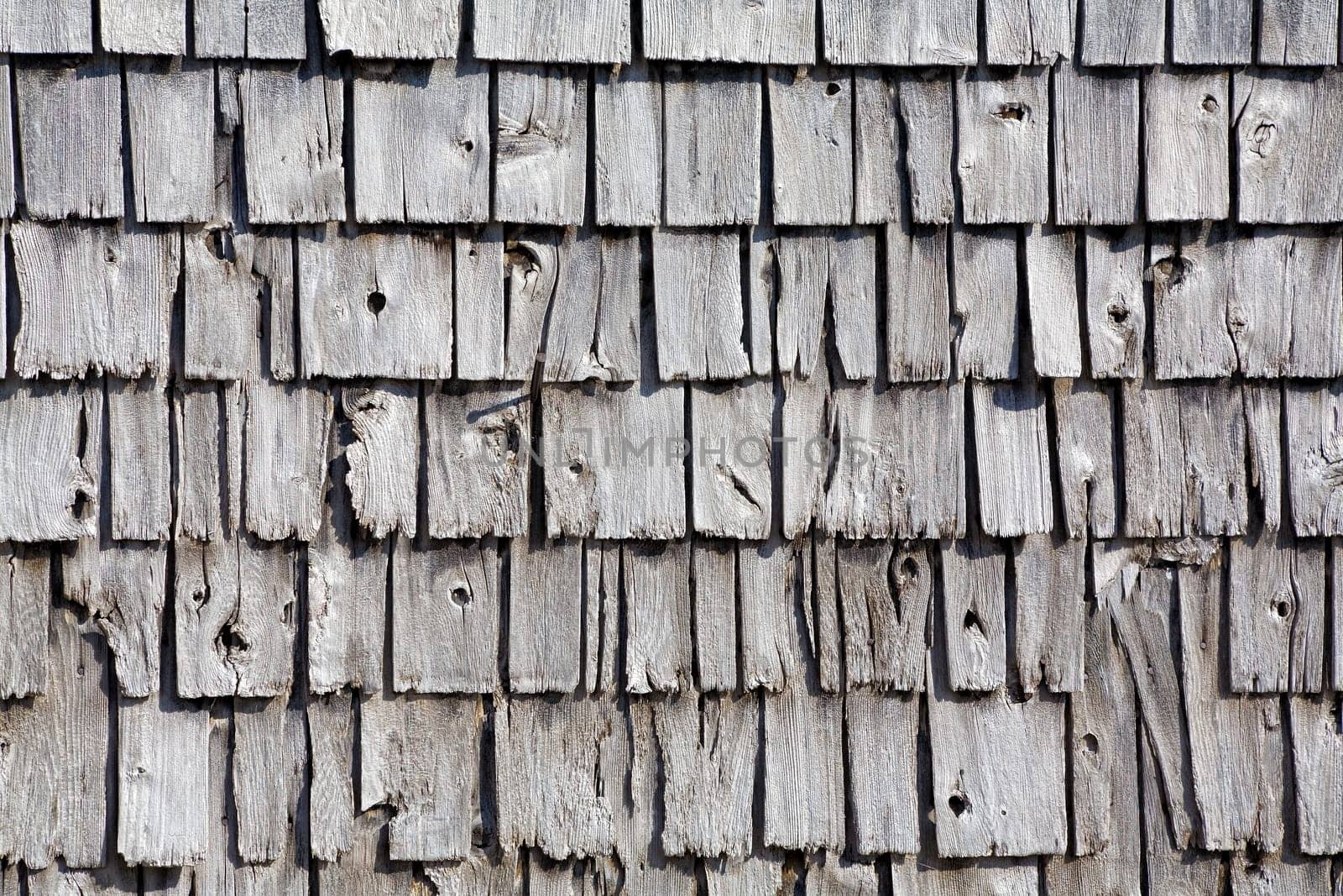 Old wooden shingle siding. Can be used as a background