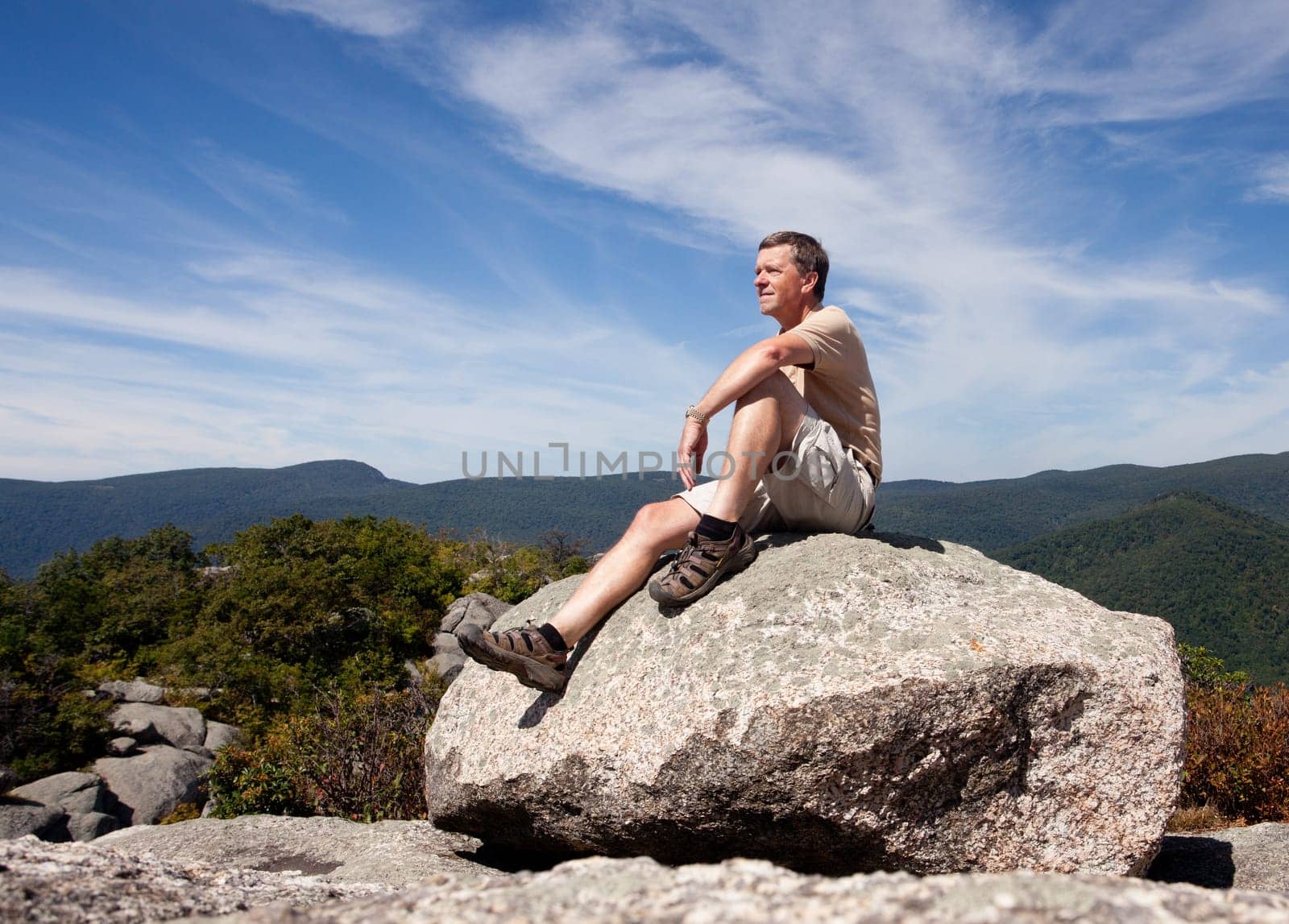 Senior hiker looks over valley in the Shenandoah on a climb of Old Rag