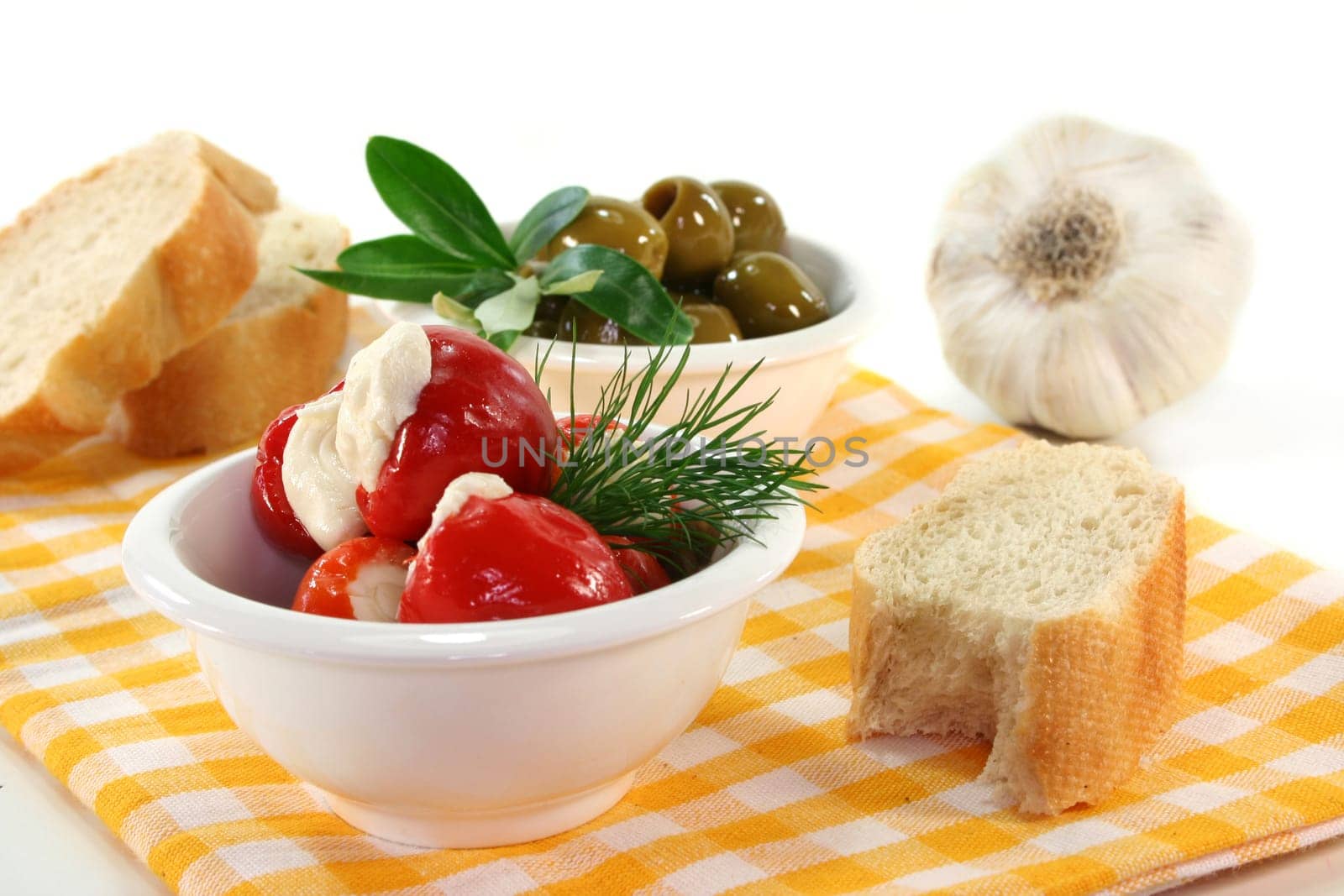 stuffed pepperoni and green olives in white bowls