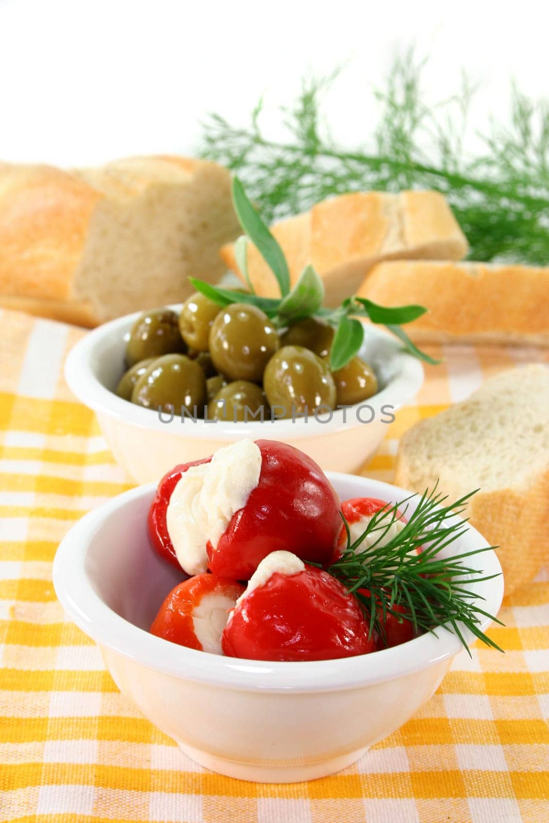 stuffed pepperoni and green olives in white bowls