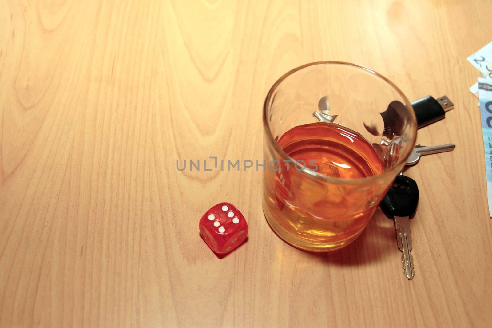 whiskey glass and keys and dice on office desk depicting dont gamble with your life