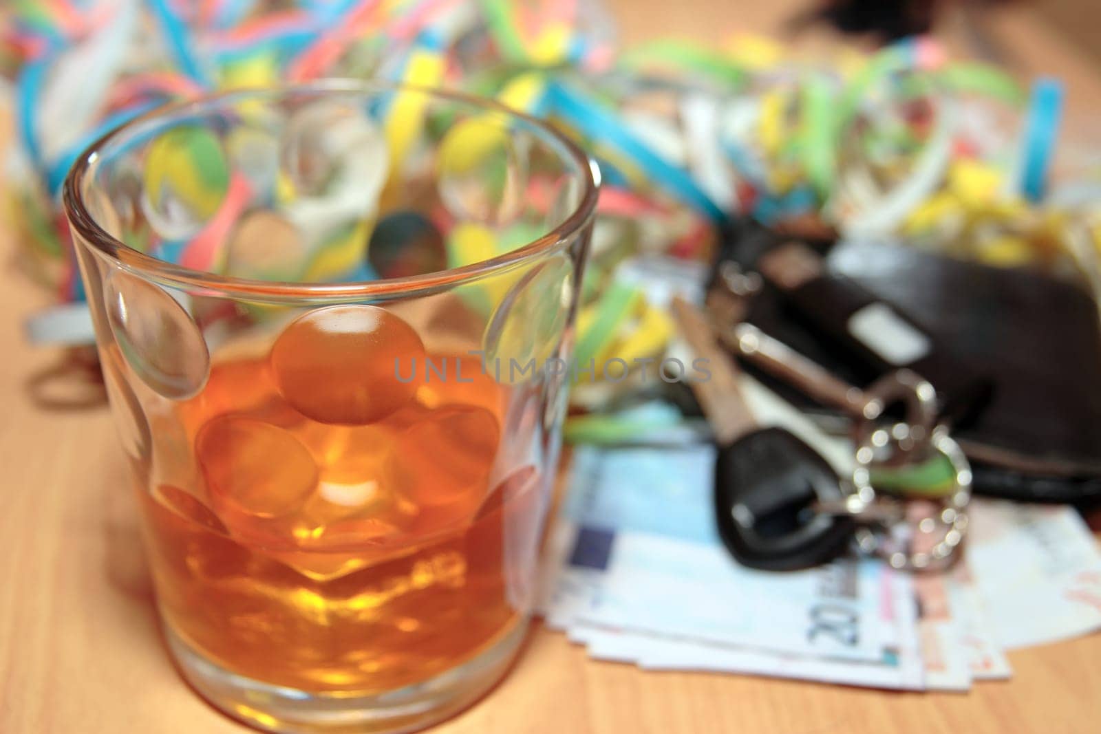wallet whiskey glass and keys at office party on desk depicting dont drink and drive