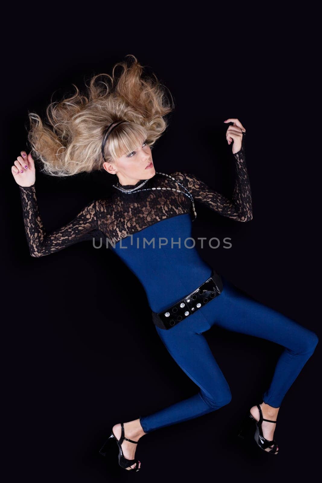 beauty young blond girl lay on black background