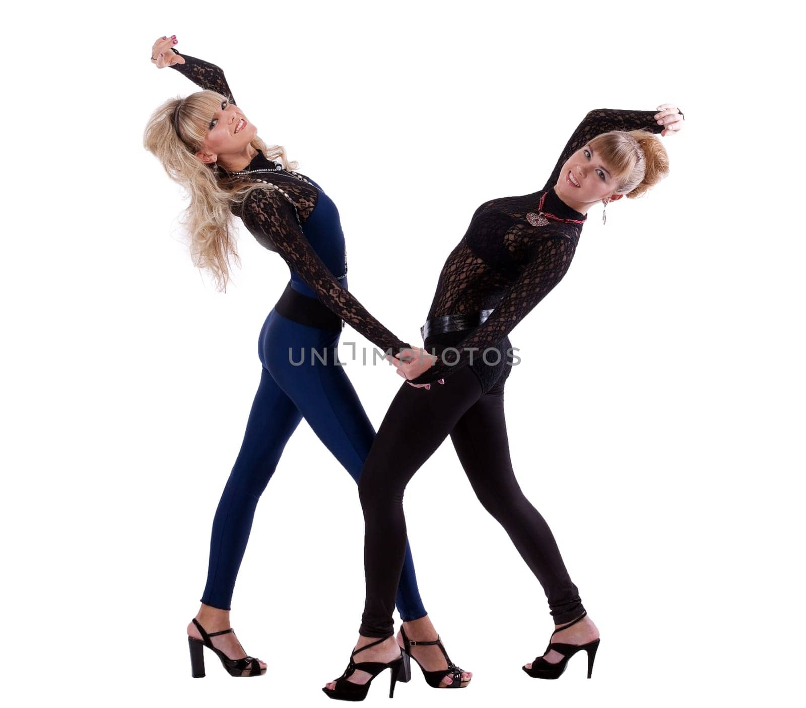 two pretty girl dance together and smile on white background