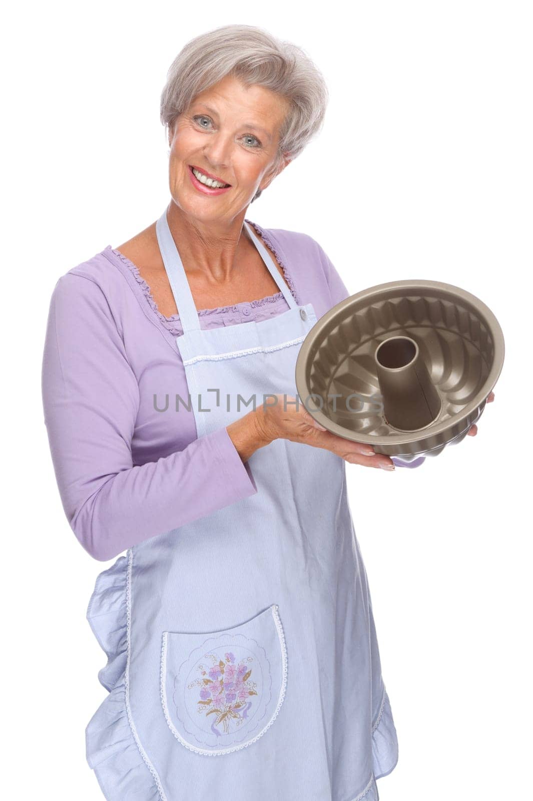 Studio shot of an active senior woman in the kitchen