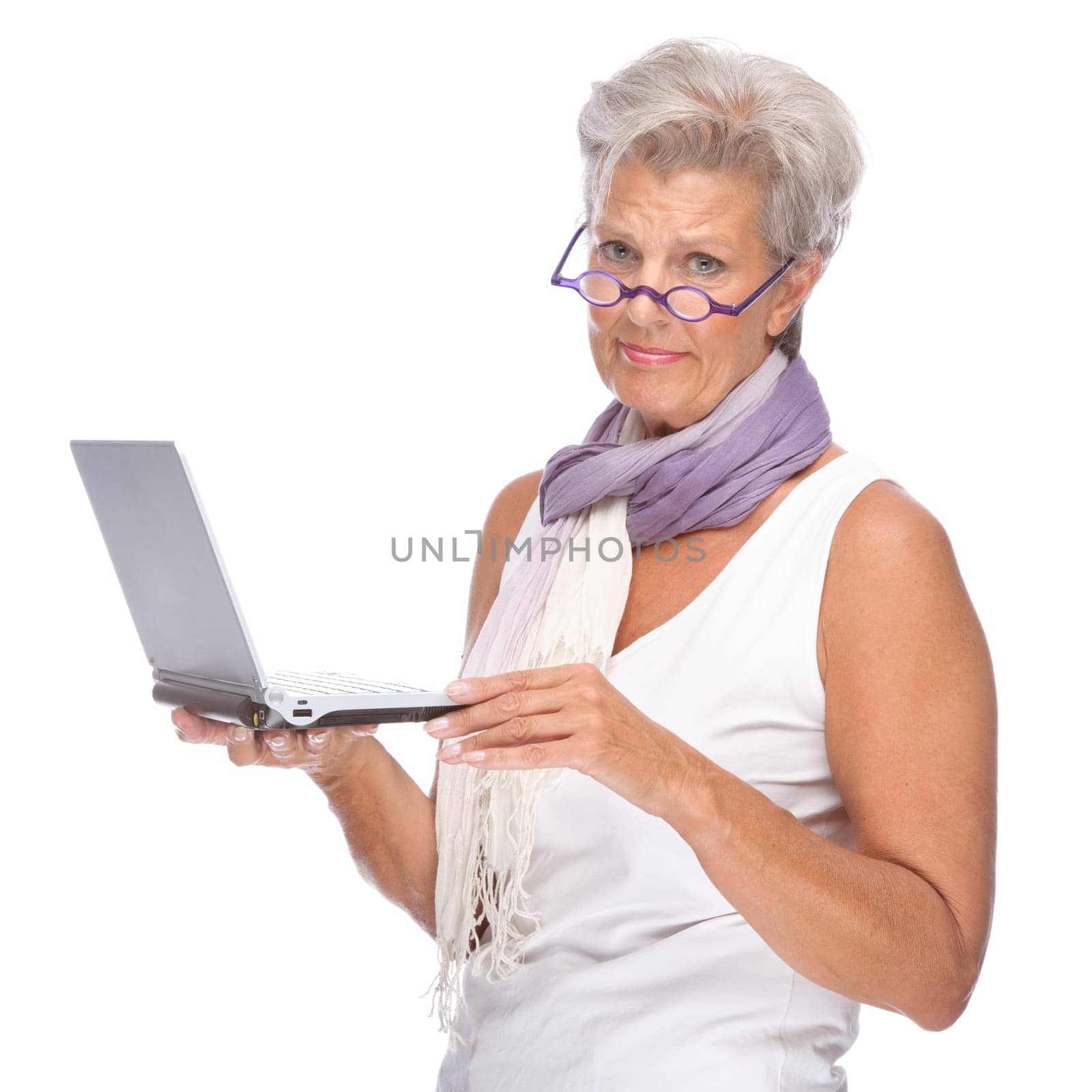 Studio shot of an active senior woman using a notebook