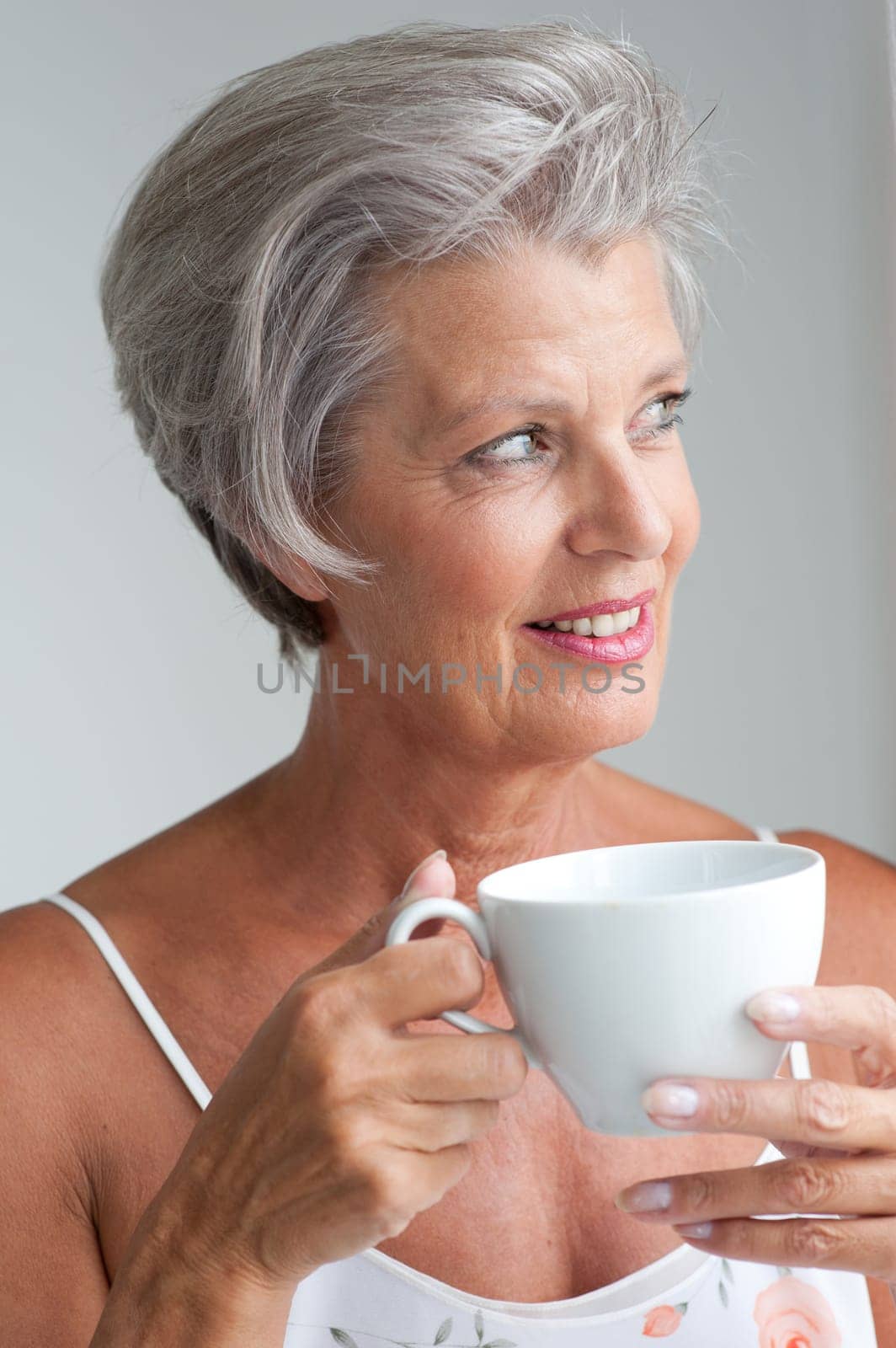 Active senior woman in the morning with a cup of coffee