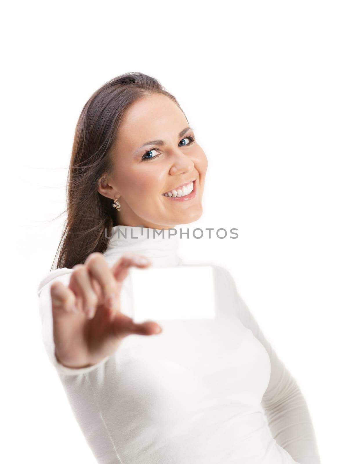 Pretty smiling girl in white shows business card  isolated on white