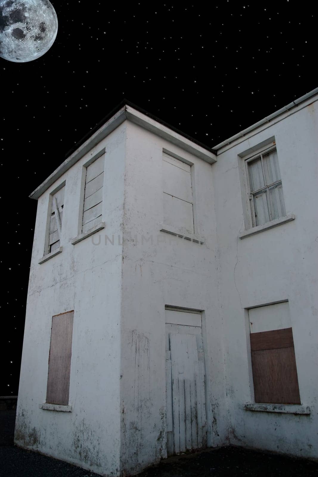 an old abandoned facade lit up in the moonlight