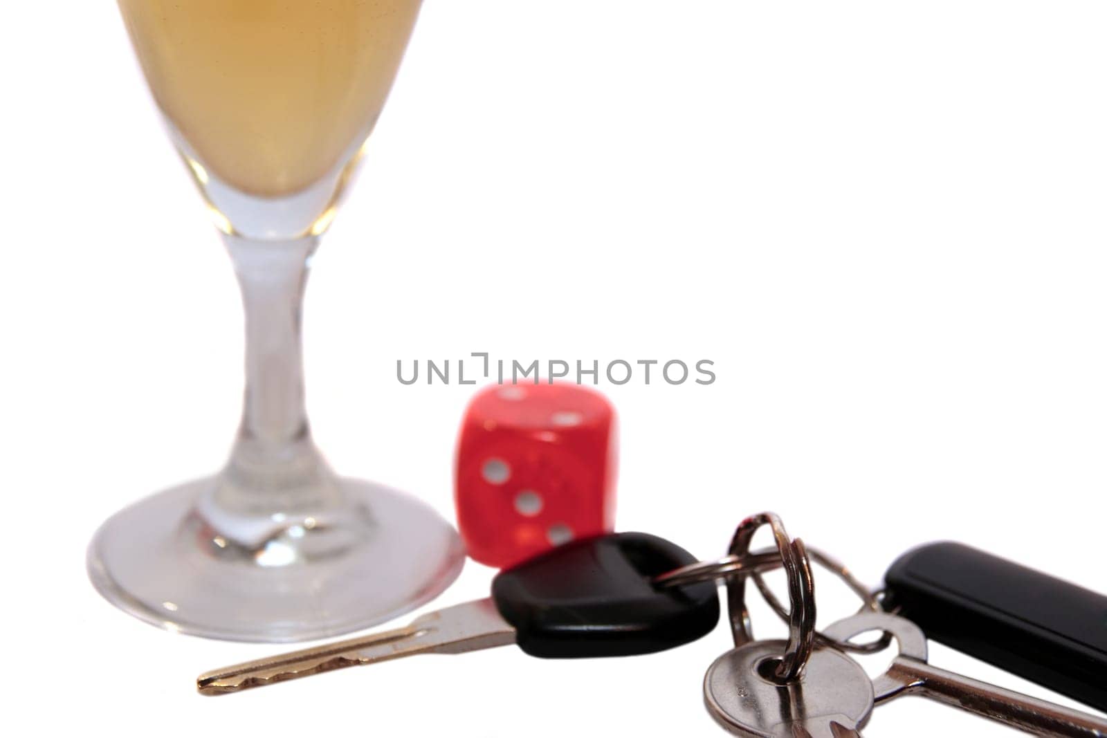 dice and champagne flute with car keys on white background depicting gambling with drunk driving and addictions can kill