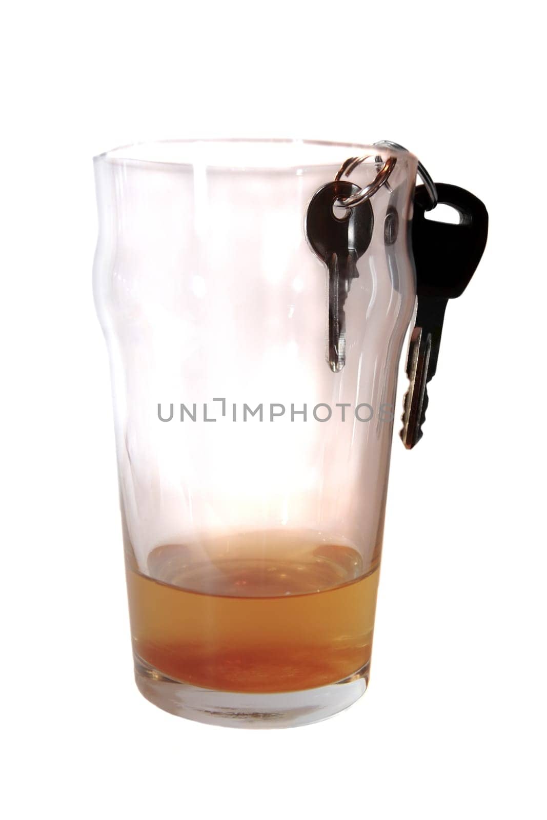 pint beer glass with car keys inside glass on white background depicting drunk driving and addictions can kill