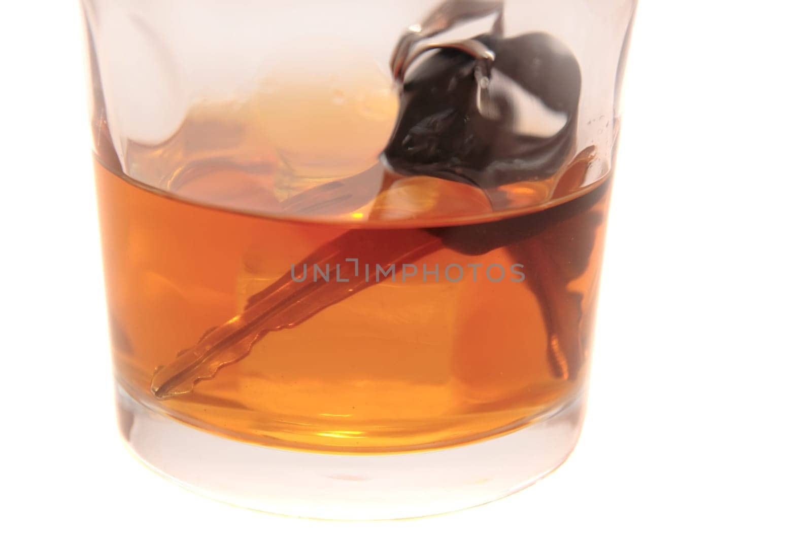 whiskey with keys inside glass on white background depicting drunk driving and addictions can kill