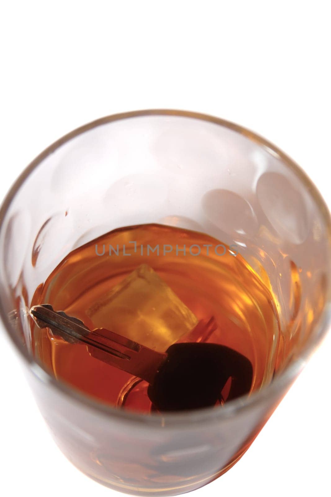 whiskey with keys inside glass on white background depicting drunk driving and addictions can kill