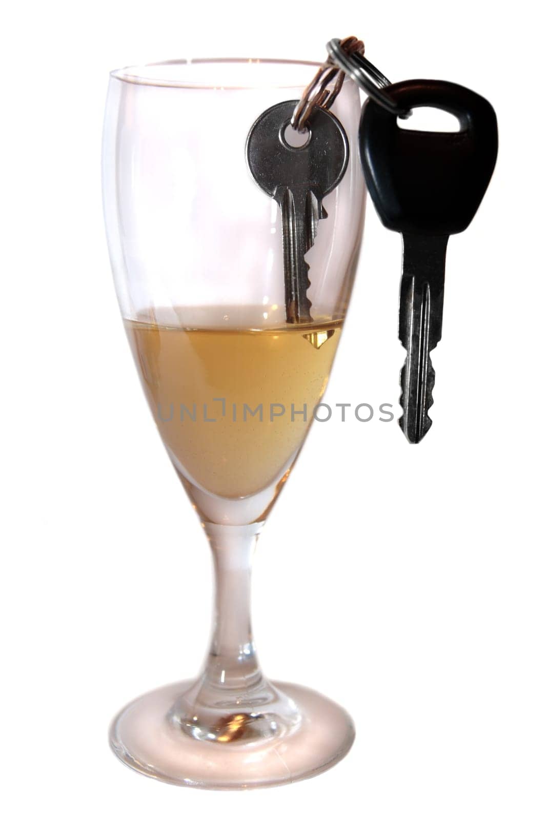 champagne or lager with keys inside glass on white background depicting drunk driving and addictions can kill