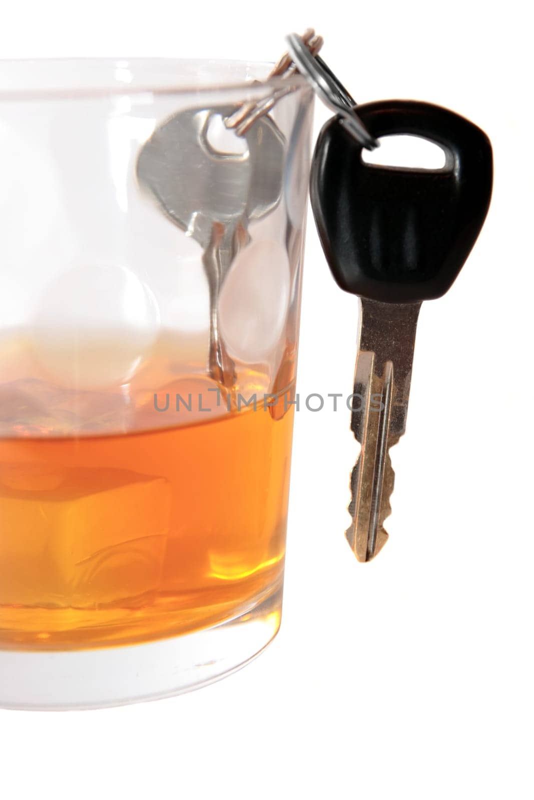 bourbon with keys inside glass on white background depicting drunk driving and addictions can kill