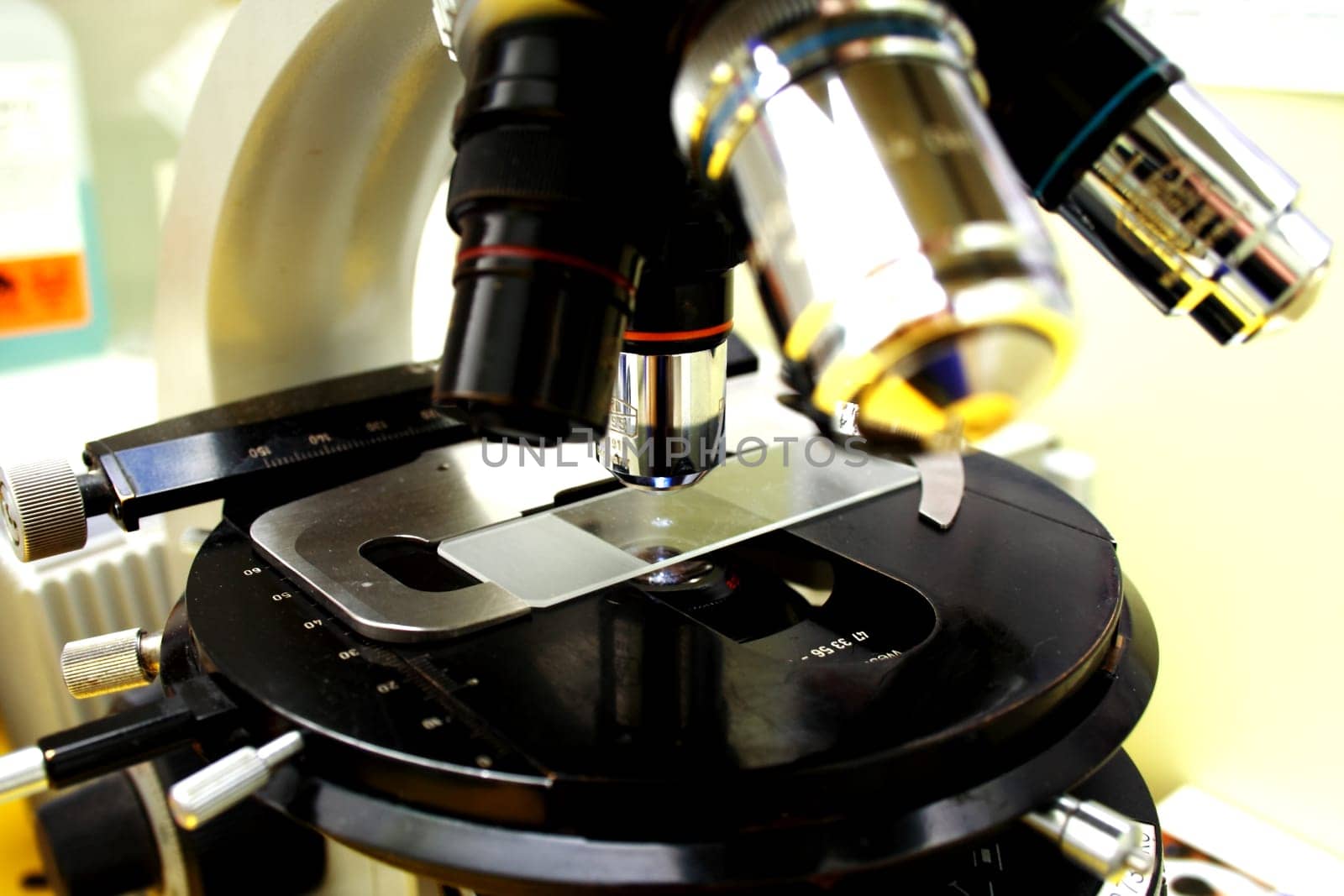 Close up of microscope lenses focused on a specimen