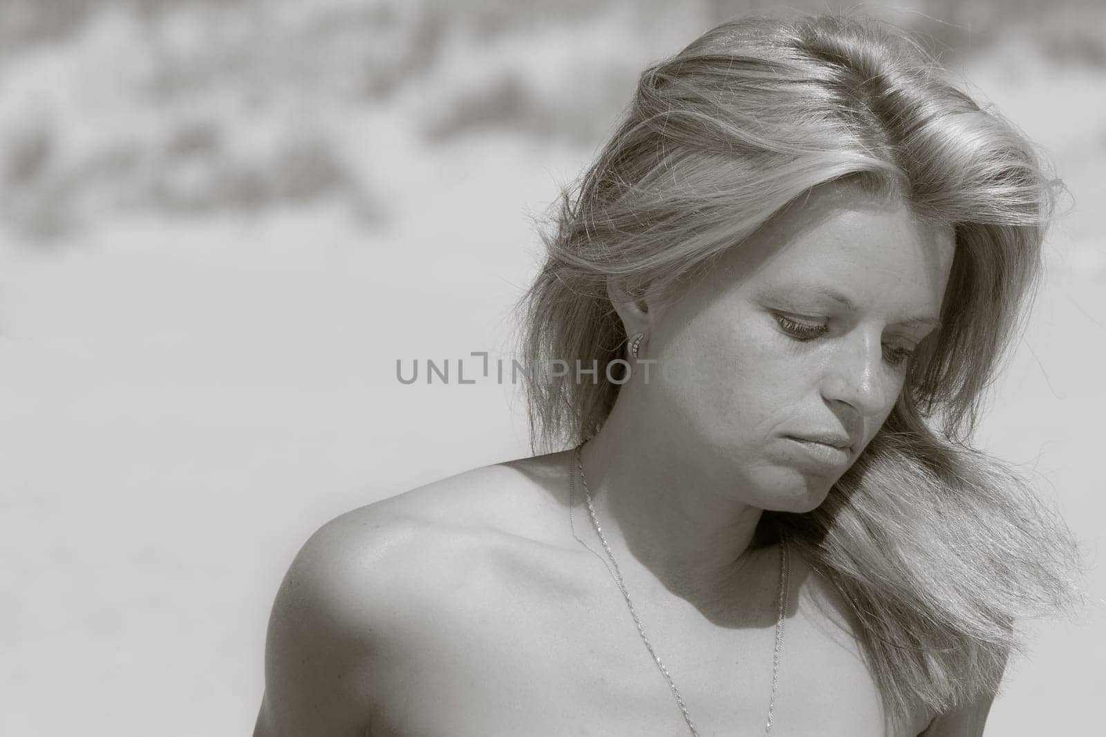 Sadly nude woman on a beach black and white