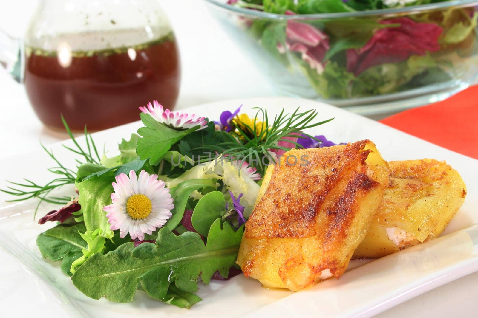 Wild herb salad with goat's cheese baked in a potato coat