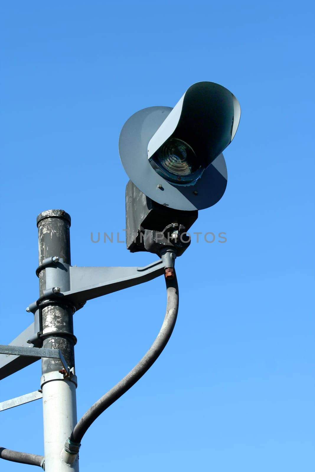 A Railroad signal light against blue sky