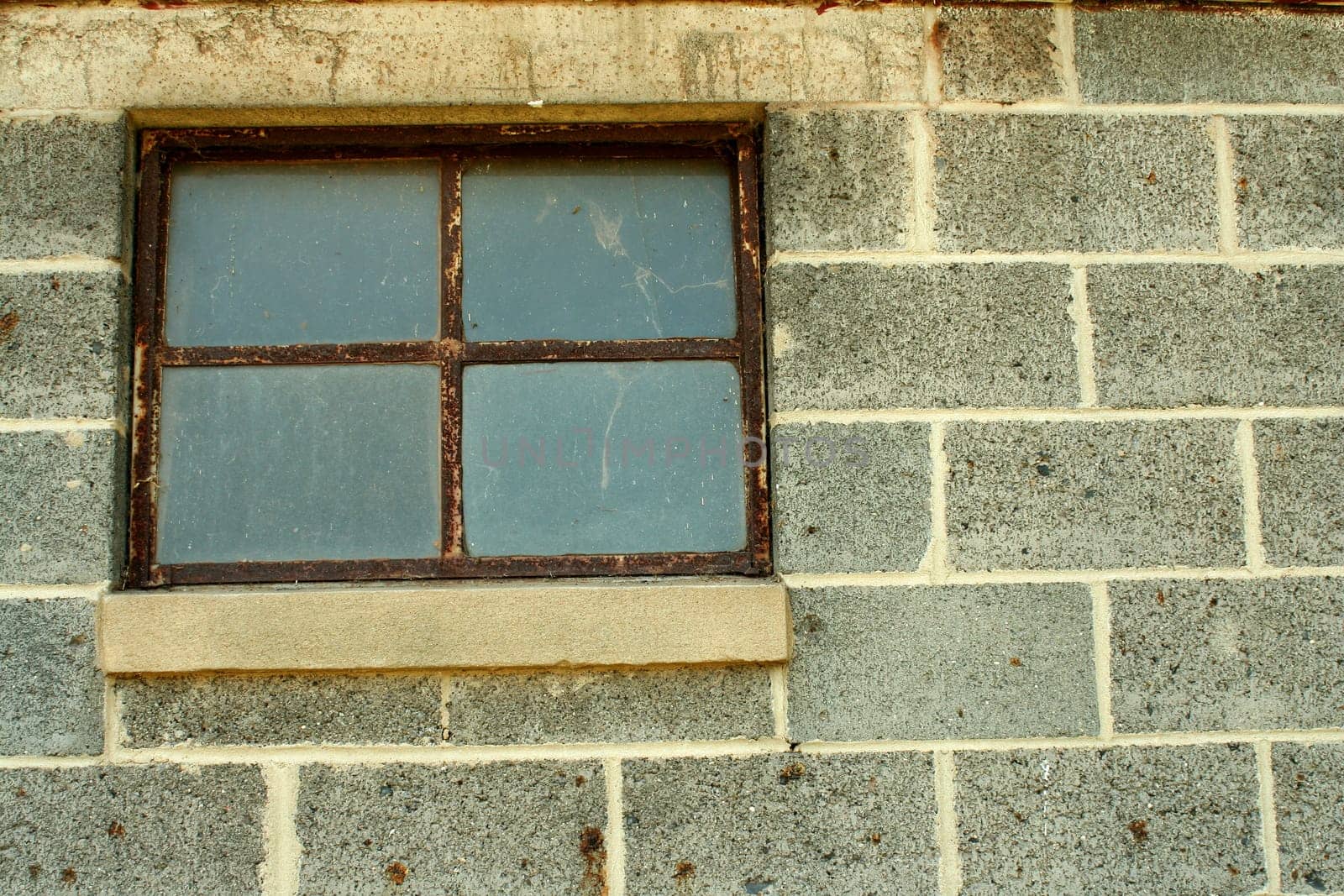A Concrete block wall with window