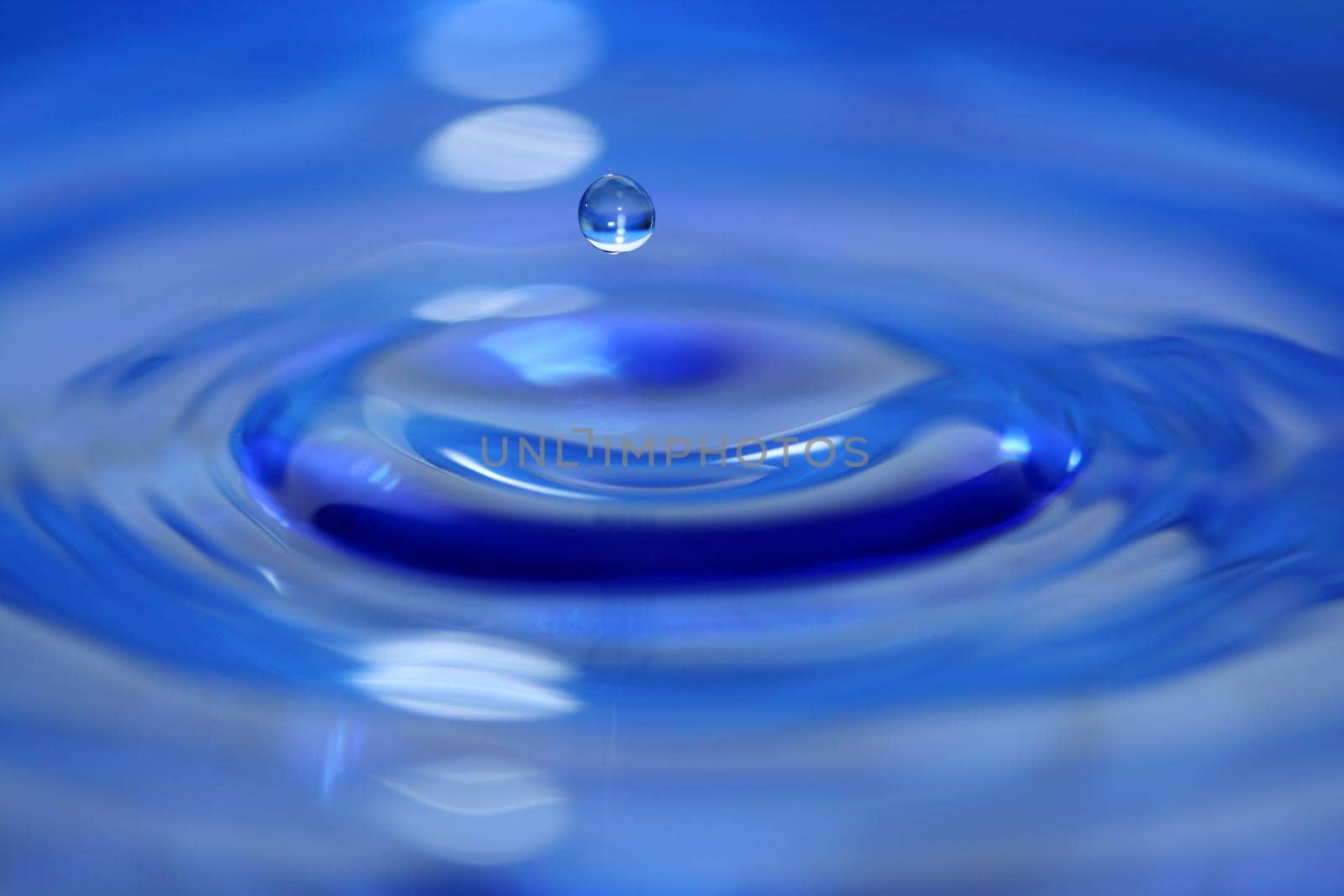 A Blue water droplet falling