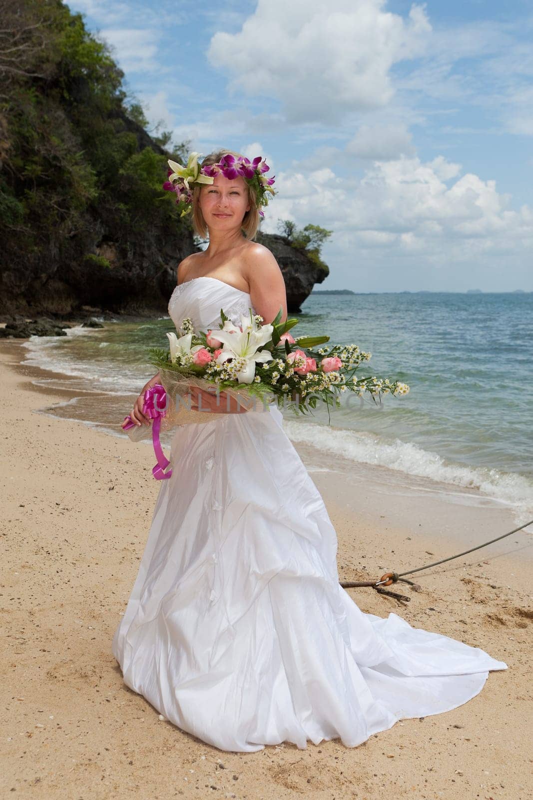 Bride on the beach,in a white dress by the sea in Thailand