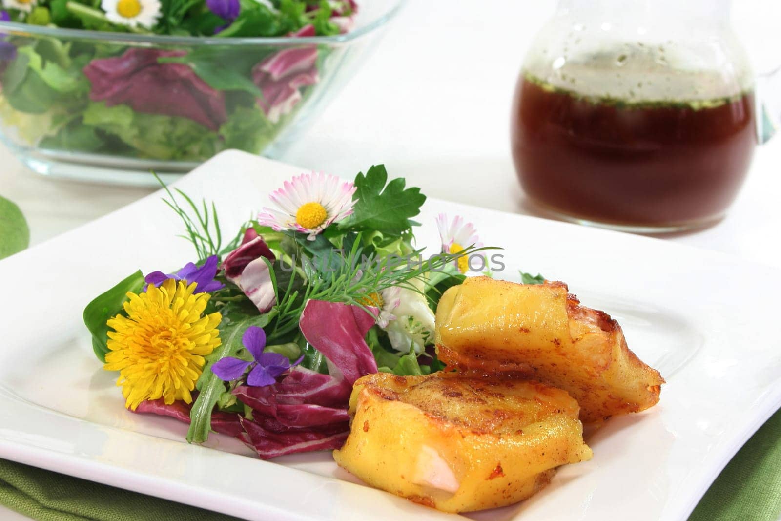 Wild herb salad with goat's cheese baked in a potato coat