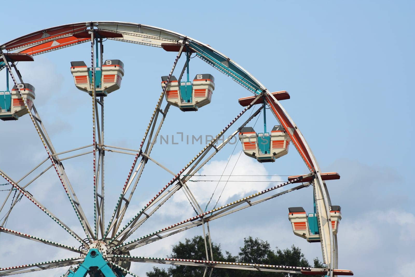 Ferris wheel against bule sky with clouds