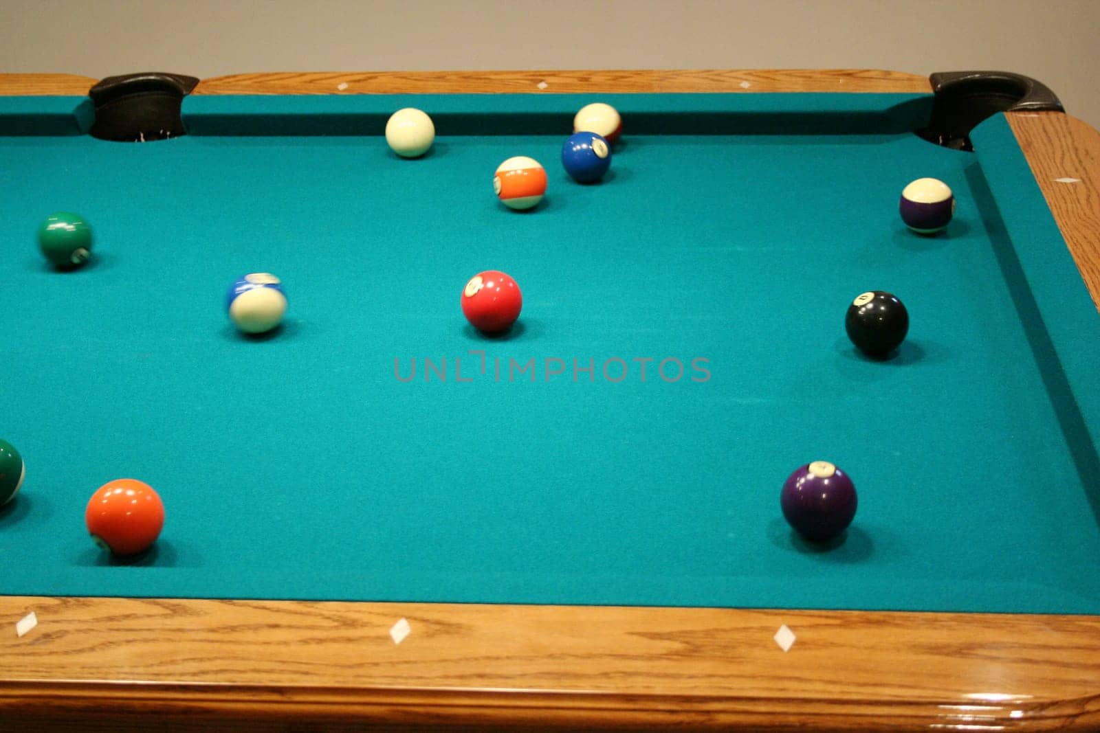 8 ball game in progress on green pool table
