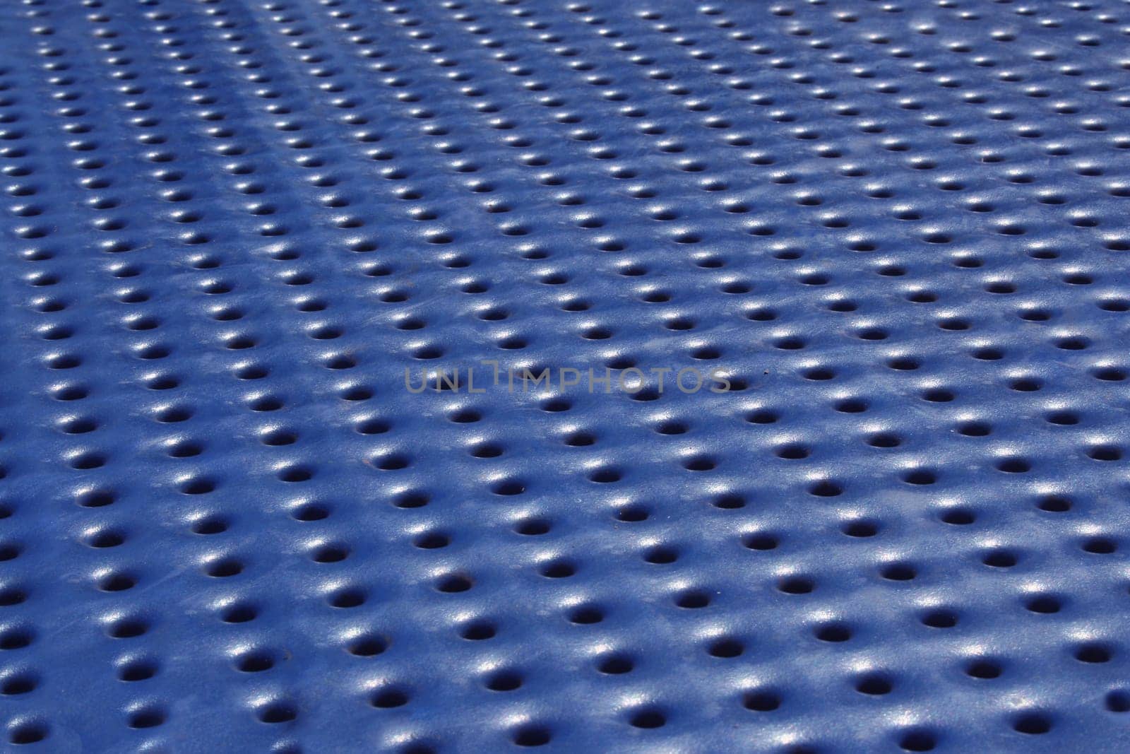 a Blue metal background with holes