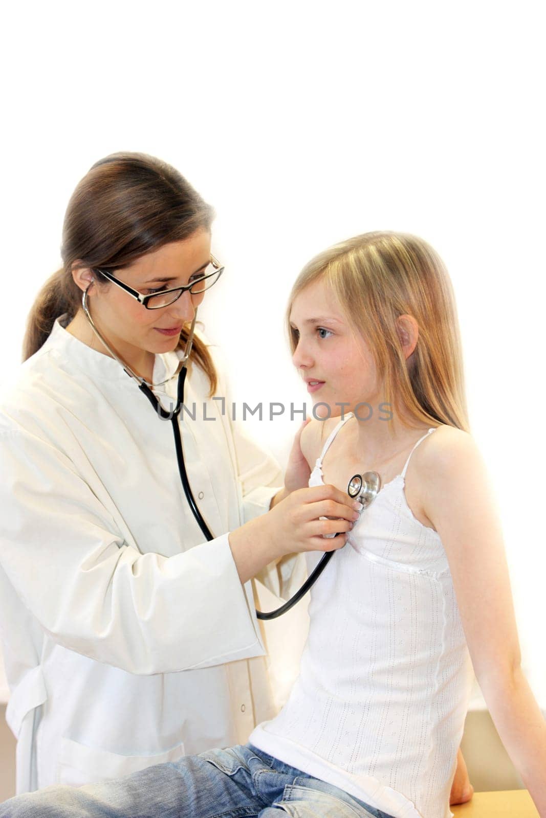 Female doctor examining a child with a stethoscope