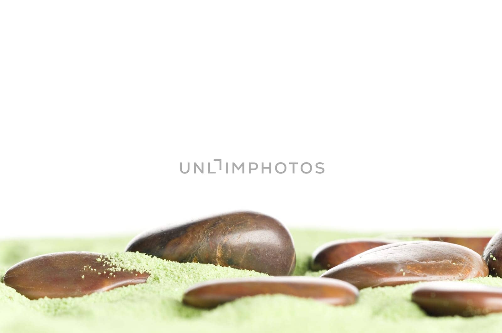 Brown stones messed up on green sand