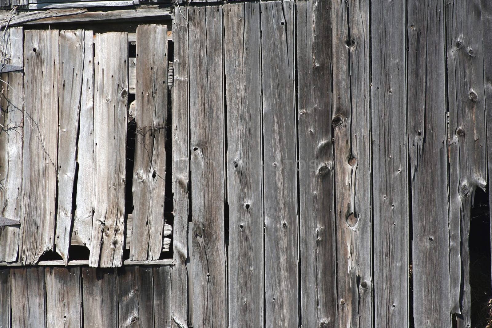An Old wooden barn with a closed window