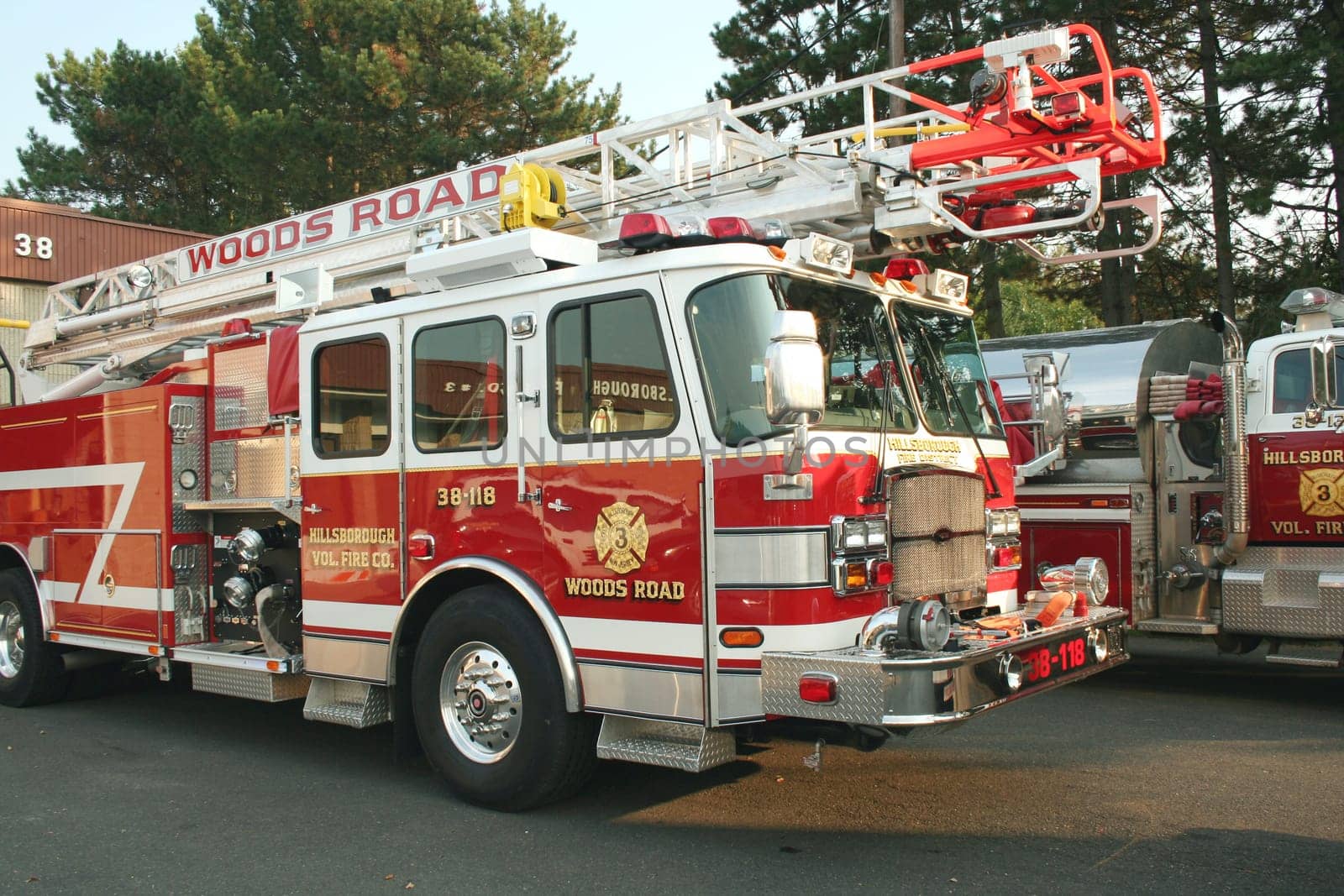A Fire Truck parked outside a firehouse