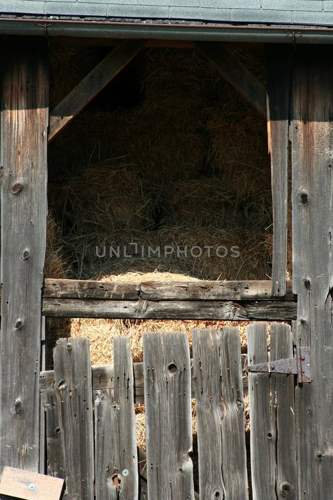 An Old wooden barn with bails of hay