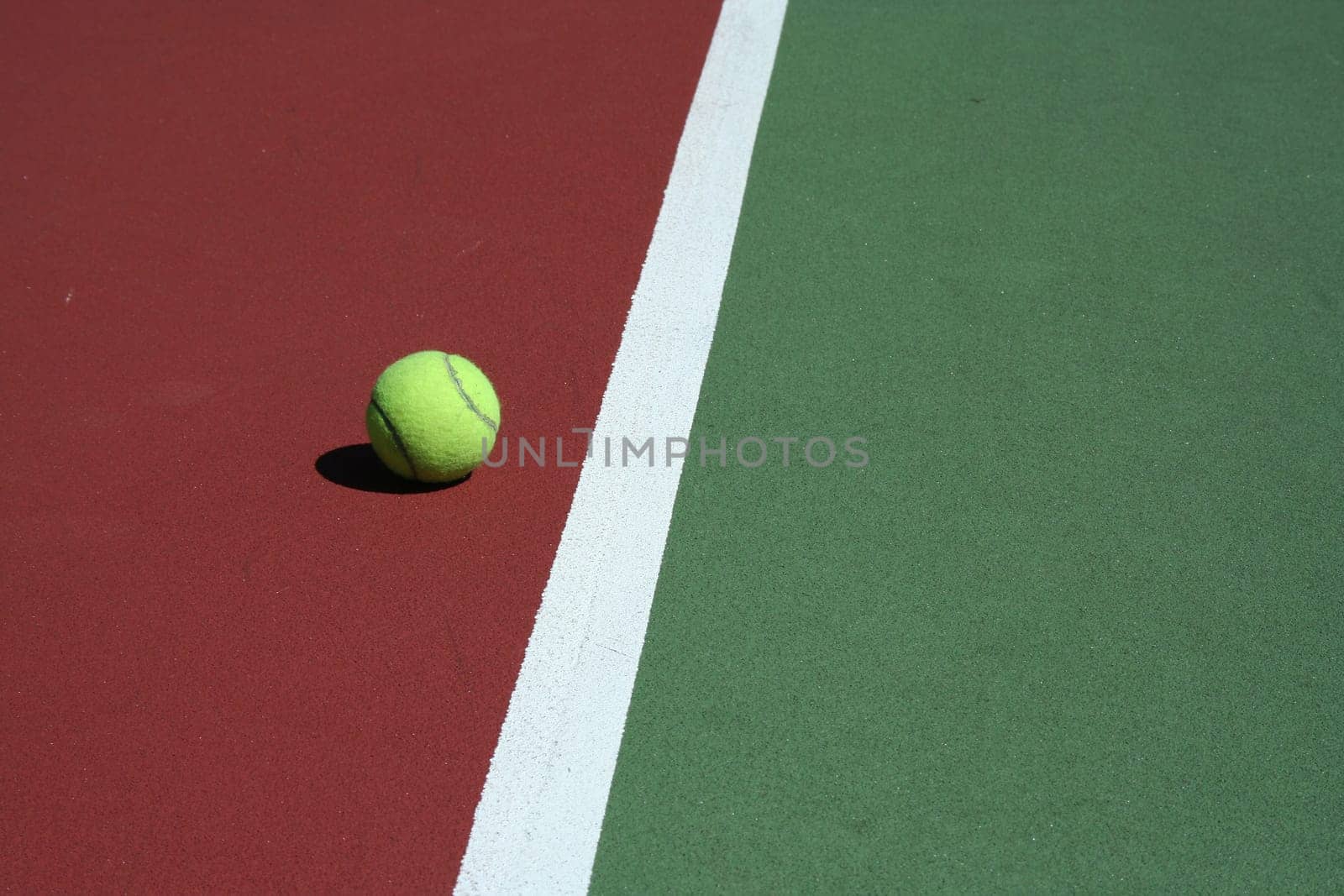 A Tennis Ball out of bounds with white line