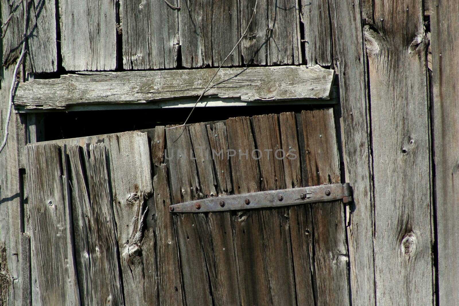 An Old wooden barn door and hinge