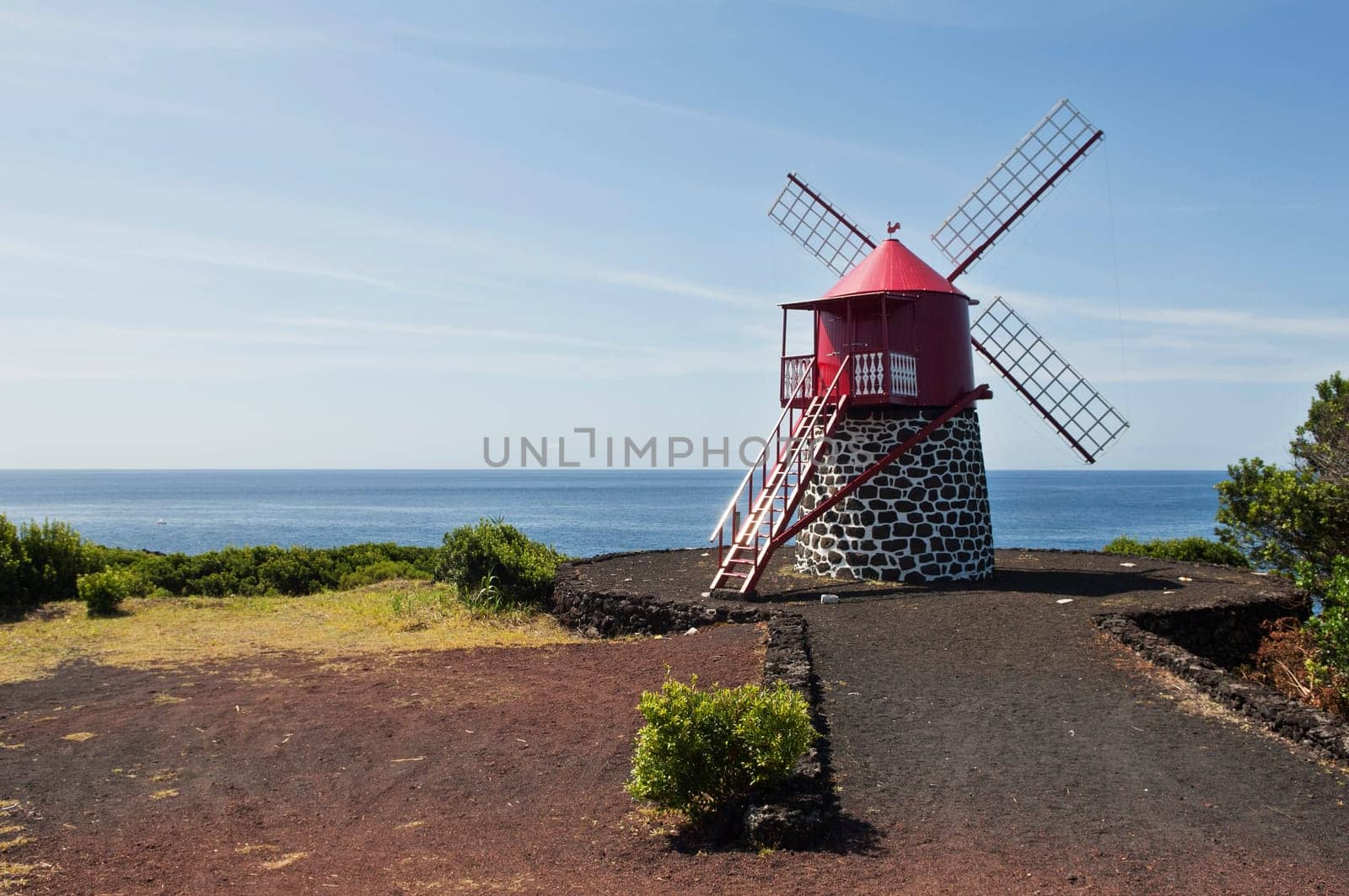 Red windmill in the coast of Pico island, Azores
