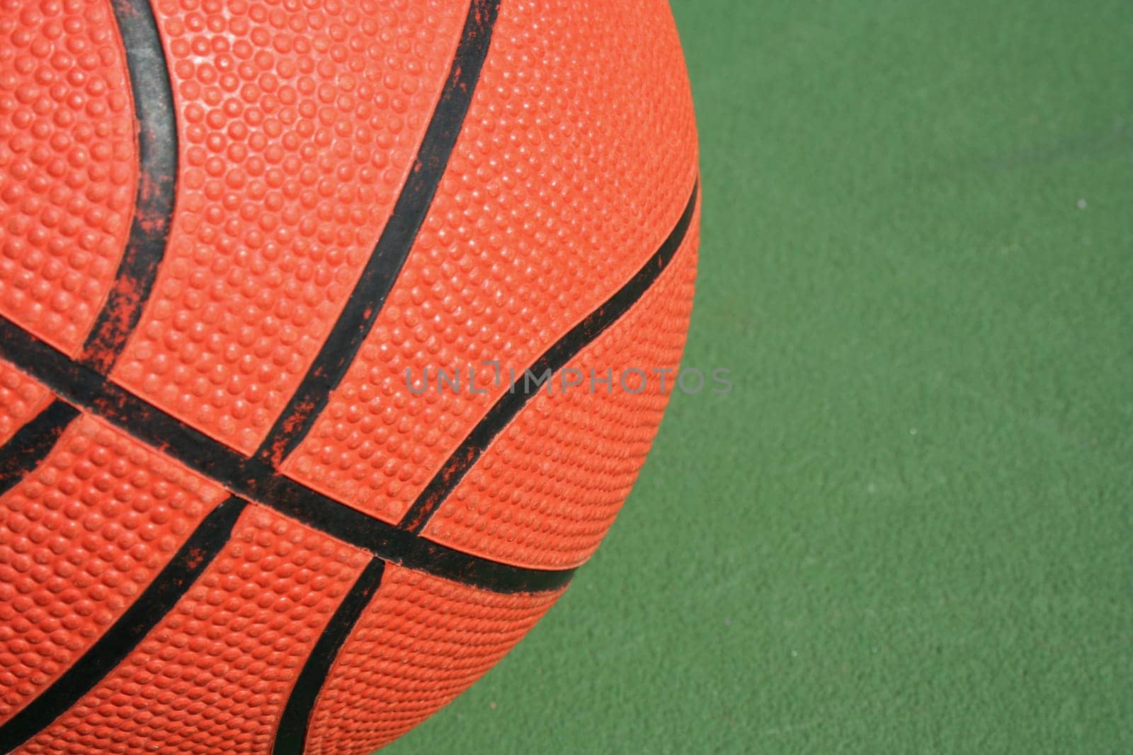 A Basketball close up on green court