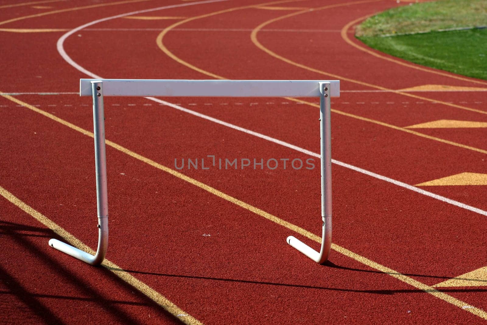 A hurdle on a red running track