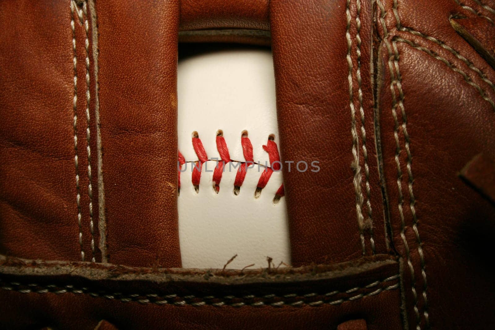 A close up of a Baseball in a glove