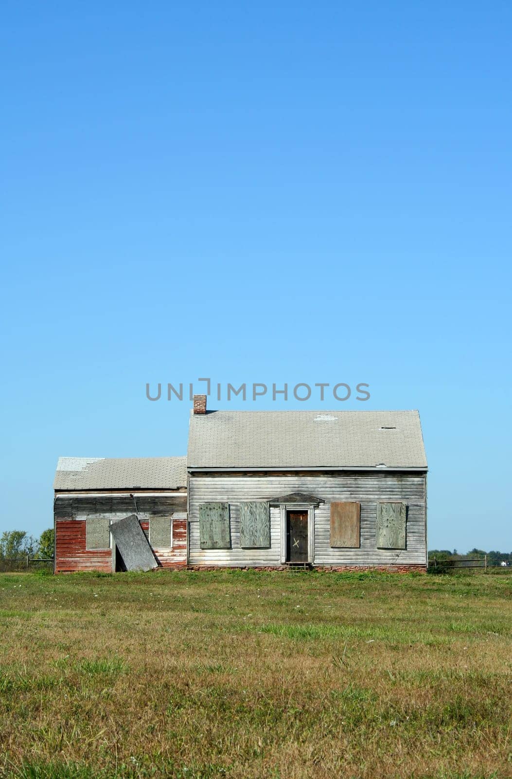 An Old abandoned house with grass and sky
