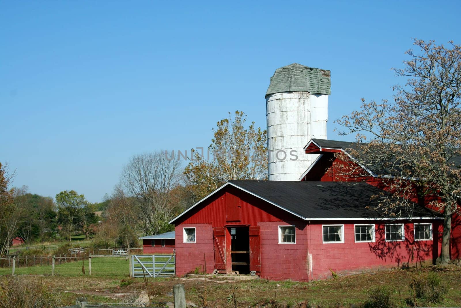 A Red Barn and silo against blue sky