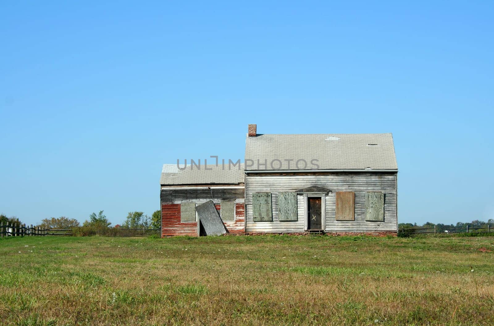 An Old abandoned house with grass and sky