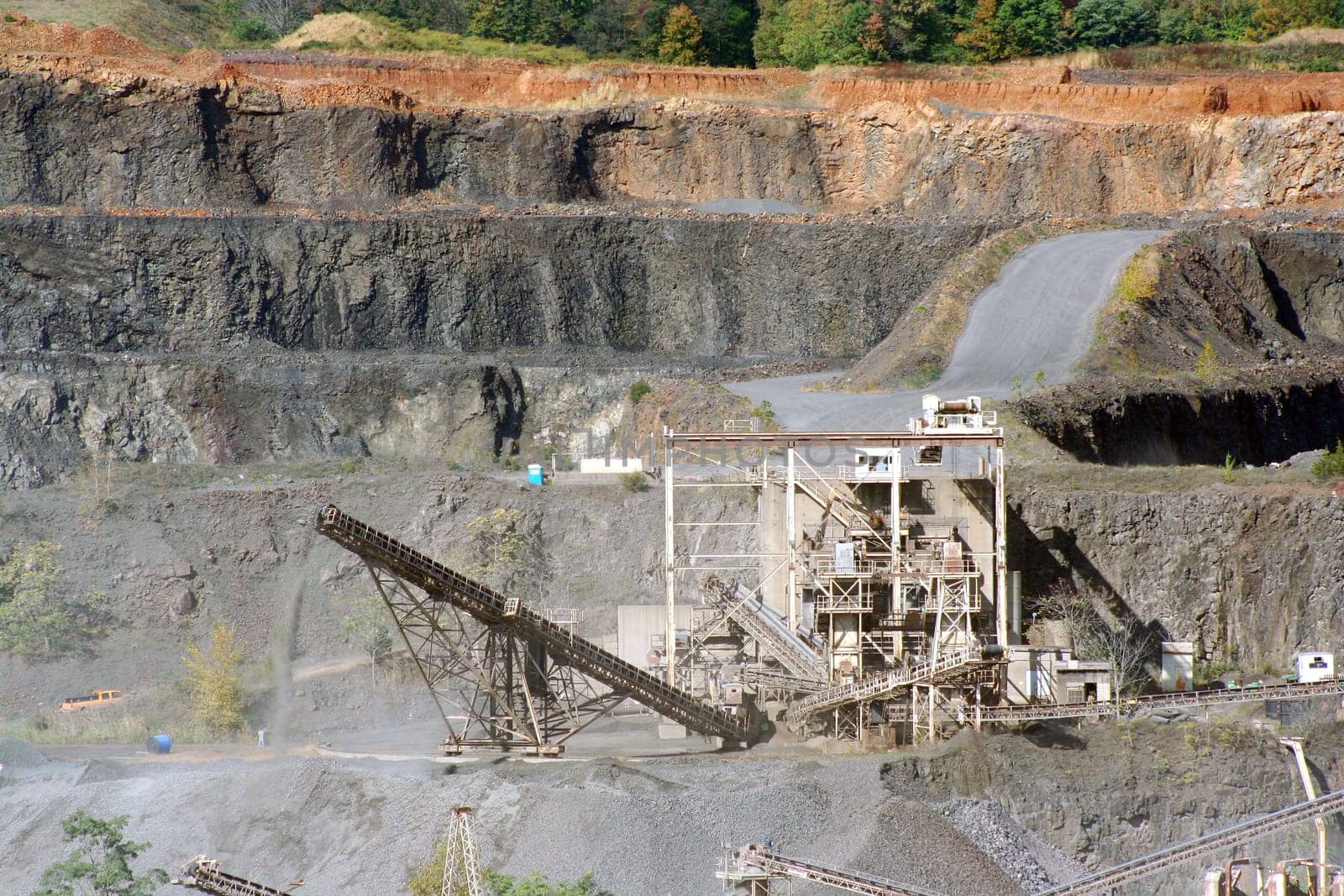 A Rock Quarry with equipment and road
