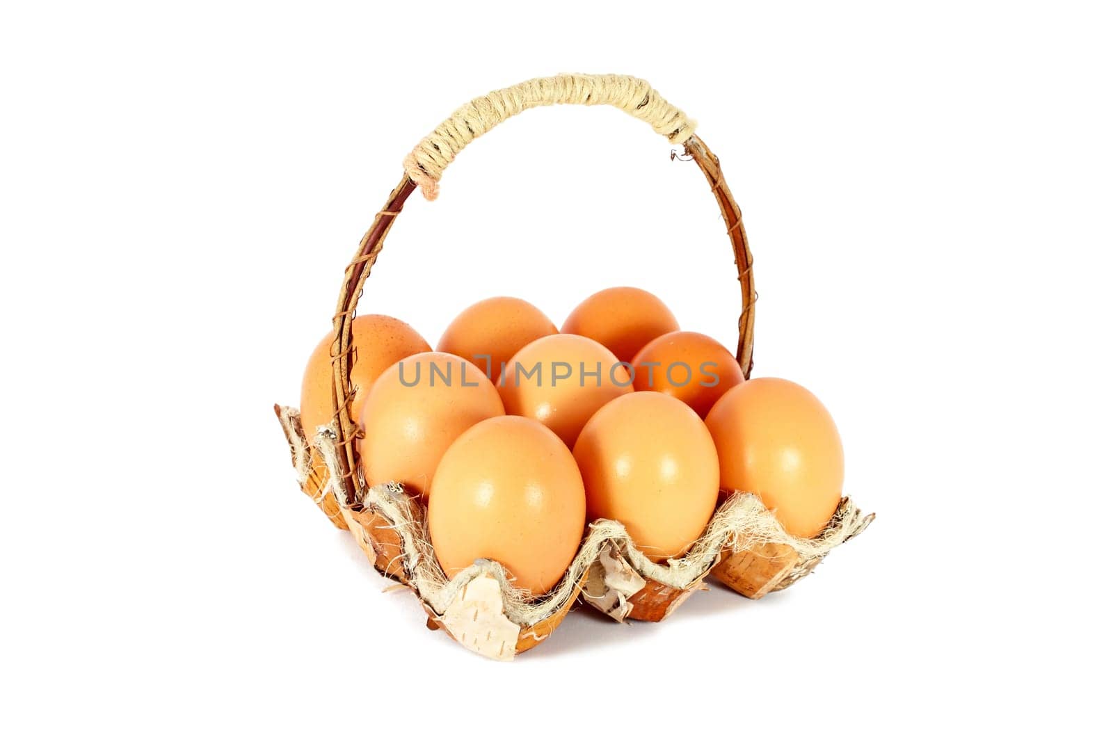Chicken eggs in a basket made of natural materials, isolated