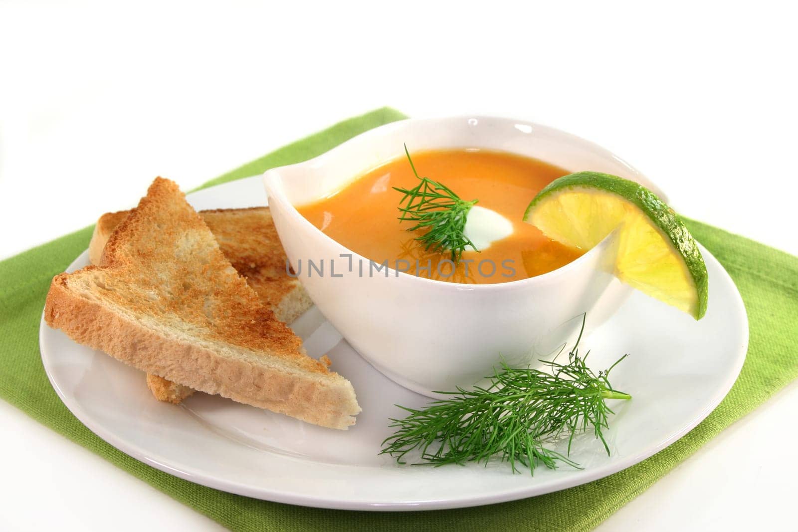a bowl of salmon cream soup with cream and dill