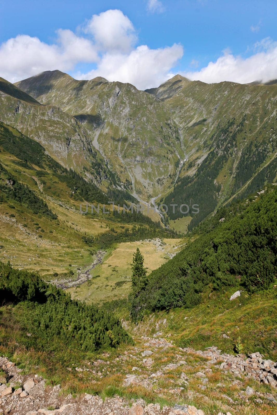 a deep mountain valley and a sky with clouds