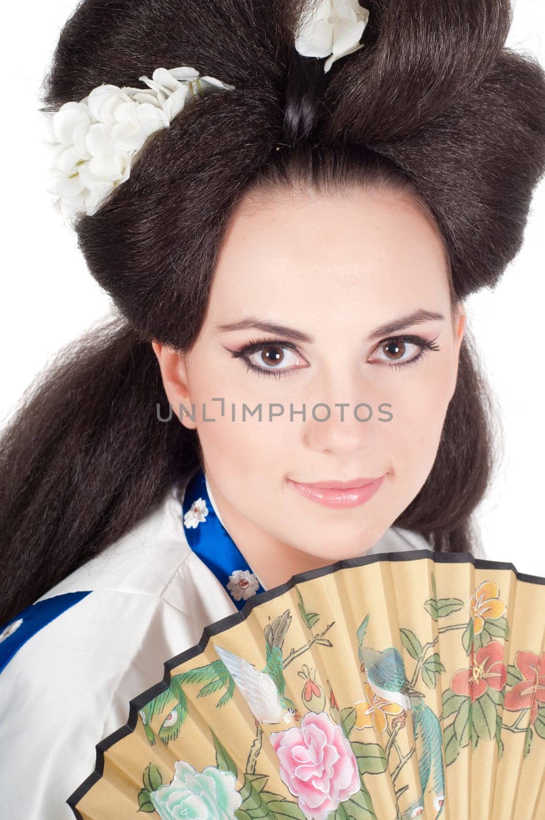 Portrait of the girl of the Asian appearance with a make-up under the geisha on a white background