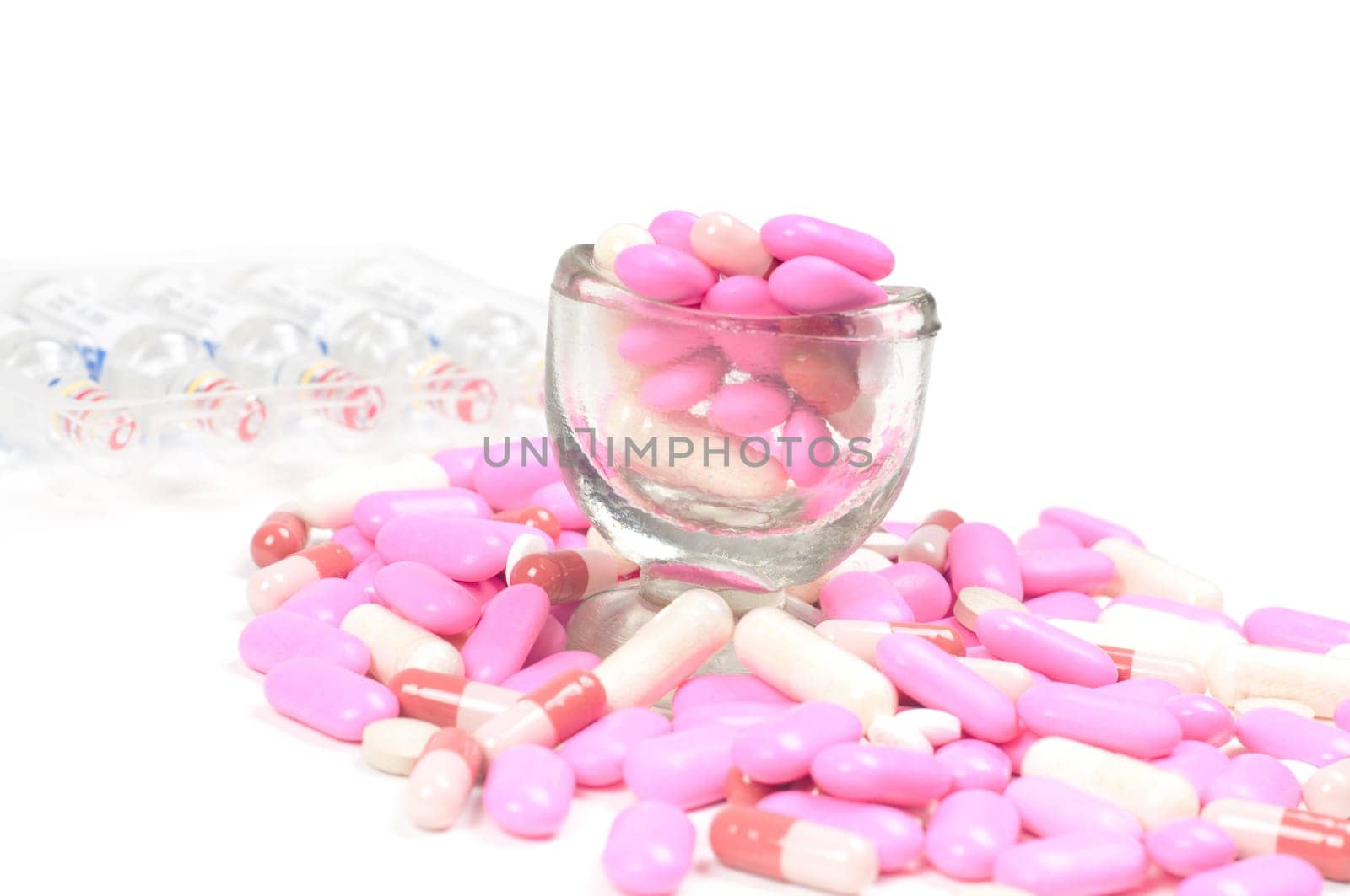 Shot of pink drugs (tablets) isolated on white